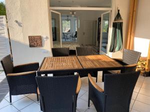 a wooden table and chairs on a patio at Ferienwohnung Auszeit in Boppard +4 photos