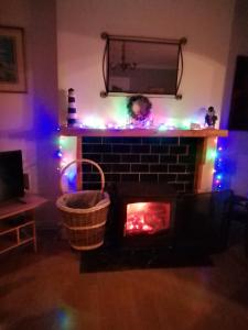 a living room with a fireplace with christmas lights at MOORINGS Greenway in Newport