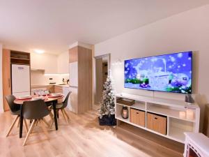 a living room with a large flat screen tv on a wall at Apartamento Romántico & Céntrico En Encamp - 4pax in Encamp