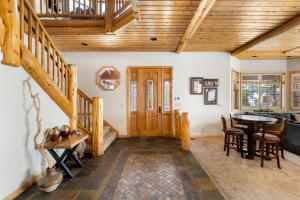 a living room with a wooden door and a table at 59 - Lakeview Lodge home in Big Bear Lake