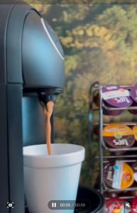 a coffee maker is pouring coffee into a cup at Piaui Apart Hotel in Teresina