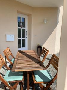 a wooden table and chairs on a patio at Eifler - Sonnenfels in Gerolstein
