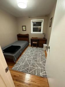 a bedroom with a bed and a desk and a window at The Versace House in Windsor