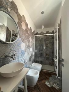 a bathroom with a sink and a toilet and a mirror at Casa Del Caval Bianco in Venaria Reale +13 photos