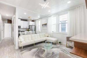 a white living room with a couch and a table at Luxury Living in the Heart of NY! in Yonkers