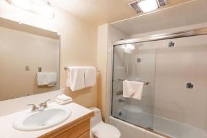 a bathroom with a sink and a glass shower at Villa Cortina Condo Next to Vail Village in Vail