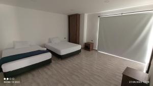 מיטה או מיטות בחדר ב-Finca Villa Maru