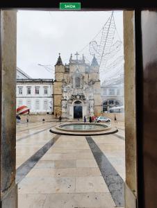 a view of a building with a fountain in front of it at Pensão Santa Cruz in Coimbra