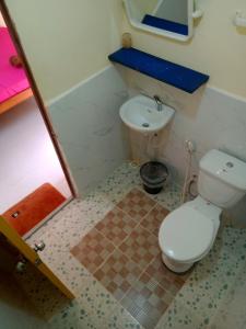 a small bathroom with a toilet and a sink at Baloo Guesthouse in Koh Rong Sanloem