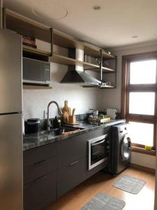 cocina con fregadero y lavavajillas en Flat reformado no Piazza Navona en Porto Alegre