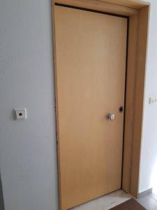 a wooden door in a room with at Cupola in Orestiada