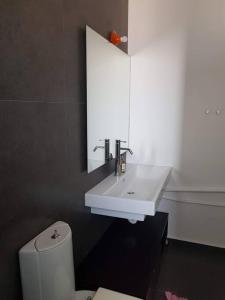 a bathroom with a white sink and a toilet at Cupola in Orestiada