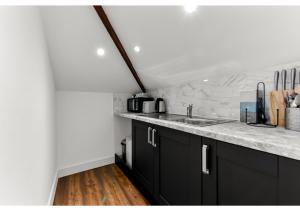 a kitchen with a sink and a counter top at Sleek and Modern Studio with Minimalist Vibe in Chelmsford