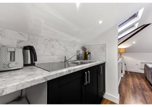 a kitchen with a sink and a counter top at Sleek and Modern Studio with Minimalist Vibe in Chelmsford