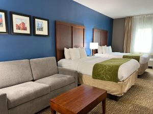 a hotel room with two beds and a couch at Comfort Suites Louisville East in Douglass Hills +175 photos
