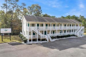 a large white house with a large front porch at Beachside Boutique Suite 1 in Sneads Ferry