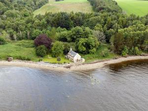 an aerial view of a house on an island in the water at St Brighs in Dingwall