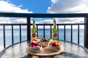 a table with two bottles of wine and bowls of fruit at Winter Rates! Oceanfront Bliss, Amazing Views 1235B in Myrtle Beach
