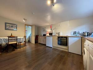 a large kitchen with a table and a dining room at Eleven Diabaig Cottage in Dibaig