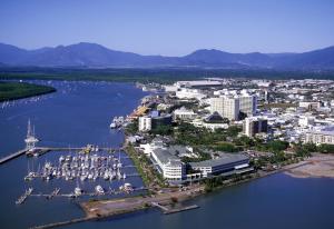 an aerial view of a city with boats in a harbor at Villa Royale in Cairns North