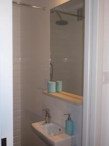 a bathroom with a sink and a mirror at Mieszkanie Przy Plaży in Gdańsk