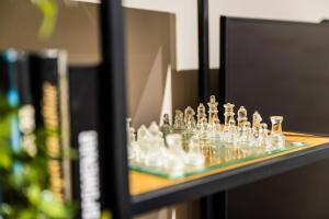a glass chess set sitting on a shelf at Super modern downtown apartment in Sarajevo +18 photos