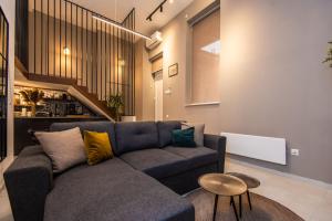 a living room with a couch and a table at Super modern downtown apartment in Sarajevo
