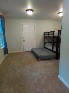 a bedroom with two bunk beds and a door at Riffle Road Ranch in Spirit Lake