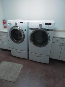 two washing machines sitting next to each other in a room at Riffle Road Ranch in Spirit Lake