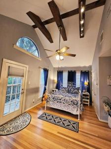 a bedroom with a bed and a ceiling fan at Charming Two Story Country Style Loft with Balcony in Houston