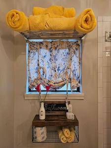 a window in a bathroom with a shelf with towels at Secluded Two Story Country Style Loft with Balcony in Houston