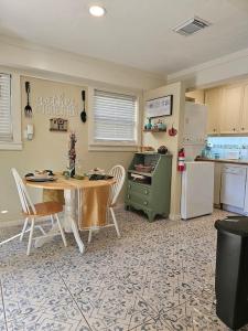 a kitchen with a table and a kitchen with a refrigerator at Charming Two Story Country Style Loft with Balcony in Houston