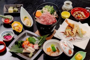 a table with many different dishes of food on it at Kiso Mikawaya in Kiso