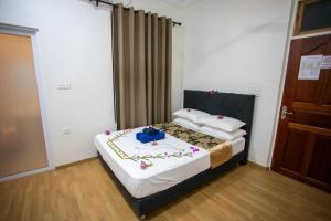 Letto o letti in una camera di iHaven Thulusdhoo