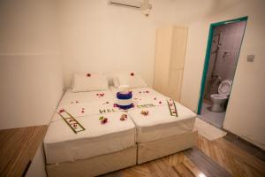Letto o letti in una camera di iHaven Thulusdhoo