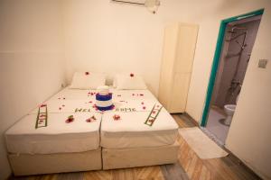 Letto o letti in una camera di iHaven Thulusdhoo