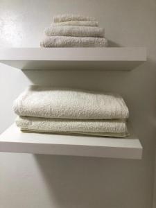 three towels on a shelf in a bathroom at The Noel At Whitwell 