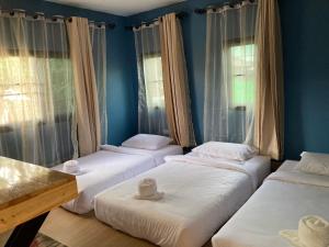 Postel nebo postele na pokoji v ubytování T&P at Pai