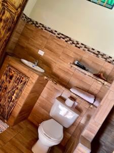 a bathroom with a toilet and a sink at Cabañas Tierra Fértil #2 