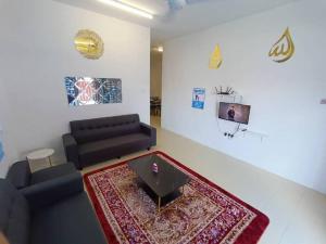 a living room with a couch and a table at Home MH Casa Damai Private Pool at Sungai Petani in Sungai Petani