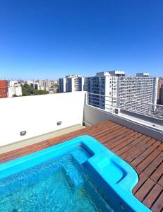 a swimming pool on the roof of a building at Dos ambientes con cochera La Boca/ San Telmo in Buenos Aires