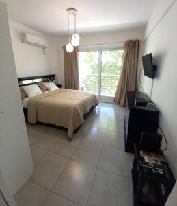 a bedroom with a bed and a large window at Dos ambientes con cochera La Boca/ San Telmo in Buenos Aires