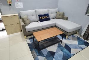 a living room with a couch and a coffee table at Akmal Homestay Klang in Klang