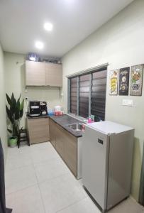 a small kitchen with a sink and a refrigerator at Akmal Homestay Klang in Klang