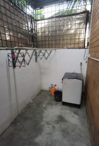 a garage with a small refrigerator and a window at Akmal Homestay Klang in Klang