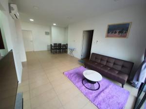 a living room with a couch and a table at Bunny Homestay 407 Roxy Apartment Kuching in Kuching
