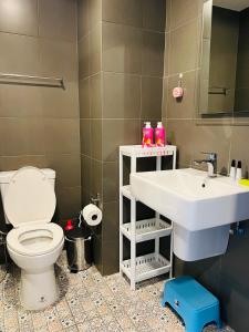 a bathroom with a toilet and a sink at HuaHin La Casita condo Quiet, cozy room Netflix#1 in Hua Hin