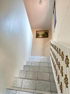 a staircase in a home with white walls at Vacation Home La Ceiba in La Ceiba