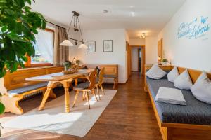 a living room with a couch and a table at Ferienwohnungen Schweiger in Ruhpolding