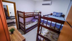 a room with two bunk beds and a sink at Chalé Amarelo in Itanhaém +45 photos